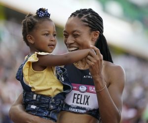 Allyson Felix celebrates after her second place finish in the women's 400-meter run with her daughter Camryn at the U.S. Olympic Track and Field Trials Sunday, June 20, 2021, in Eugene, Ore.(AP Photo/Ashley Landis)