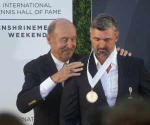 Stan Smith, left, president of the International Tennis Hall of Fame, inducts Goran Ivanisevic into the hall Saturday, July 17, 2021, in Newport, R.I. (AP Photo/Michael Dwyer)