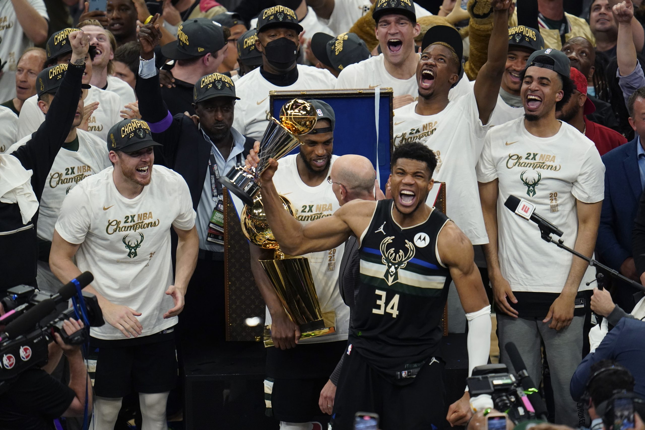 Milwaukee Bucks forward Giannis Antetokounmpo (34) holds up the MVP trophy after defeating the Phoenix Suns in Game 6 of basketball's NBA Finals in Milwaukee, Tuesday, July 20, 2021. The Bucks won 105-98. (AP Photo/Paul Sancya)