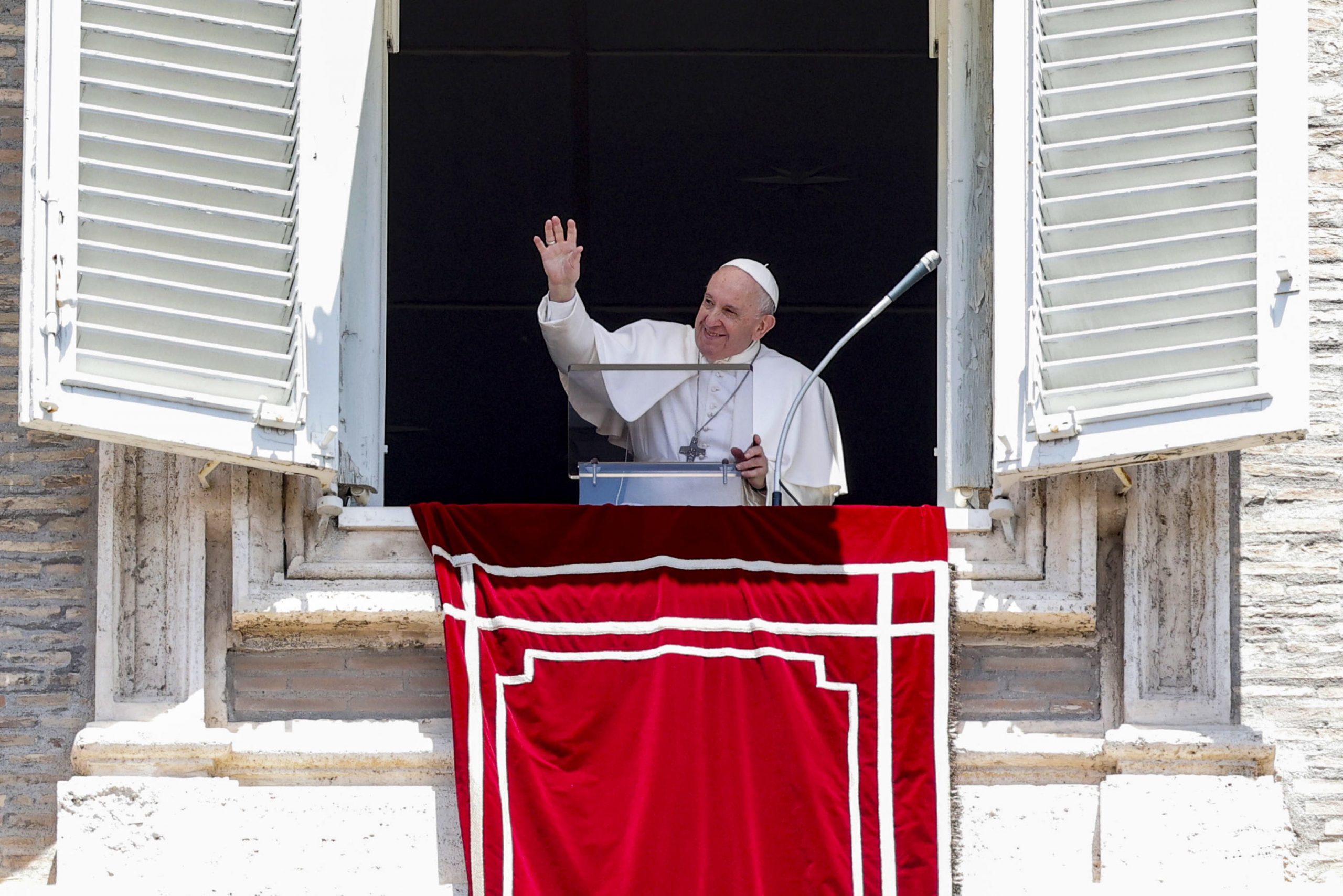 epa09304958 Pope Francis waves from the window of his office overlooking Saint Peter's Square as he leads the Angelus prayer, in Vatican City, 27 June 2021.  EPA/GIUSEPPE LAMI