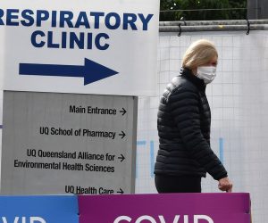 epa09314744 A woman walks outside the Brisbane South Covid Vaccination Clinic in Brisbane, Queensland, Australia, 01 July 2021.  Premier Annastacia Palaszczuk has placed south-east Queensland, Townsville, Palm Island and Magnetic Island into a 3-day lockdown.  EPA/DARREN ENGLAND AUSTRALIA AND NEW ZEALAND OUT