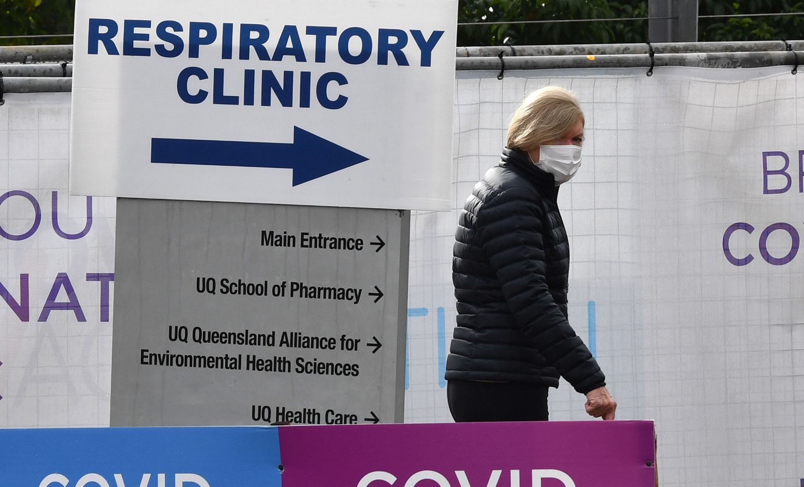 epa09314744 A woman walks outside the Brisbane South Covid Vaccination Clinic in Brisbane, Queensland, Australia, 01 July 2021.  Premier Annastacia Palaszczuk has placed south-east Queensland, Townsville, Palm Island and Magnetic Island into a 3-day lockdown.  EPA/DARREN ENGLAND AUSTRALIA AND NEW ZEALAND OUT