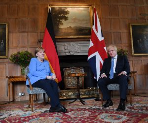 epa09317259 British Prime Minister Boris Johnson (R) with German Chancellor Angela Merkel (L) at the Prime Minster's country residence at Chequers, Buckinghamshire, Britain, 02 July 2021. The two nations have agreed a post Brexit joint declaration on foreign and security policy cooperation. The bilateral agreement is the first to be struck between London and Berlin on foreign and security policy issues.  EPA/ANDY RAIN