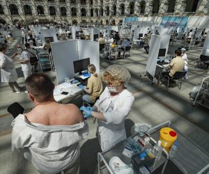 epa09325495 A man receives a shot of Russia's Sputnik V vaccine against COVID-19 disease at a vaccination center in Gostinny Dvor, a huge exhibition place in Moscow in Moscow, Russia, 06 July 2021. Moscow being the epicenter of the new outbreak of the infectious by the new Delta variant. Moscow authorities imposed a ban to serve people without QR-codes confirming vaccination against Covid-19 at public caterings, including people recovering from coronavirus Covid-19 disease within six months before the visit, or negative PCR test taken no earlier than 72 hours before the visit.  EPA/YURI KOCHETKOV