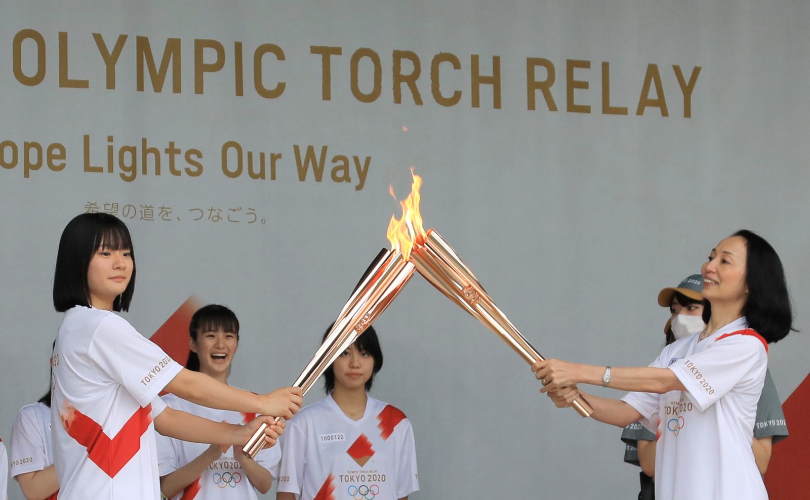 epa09333065 Torch relay runners make ceremonial lighting during a ceremony of the Tokyo 2020 Olympic Torch Relay at Machida in Tokyo, Japan, 09 July 2021. The Tokyo 2020 Olympic Torch Relay finally arrived in Tokyo on 09 July, two weeks before the opening of the Tokyo 2020 Olympic Games, which was delayed for one year due to the COVID-19 Coronavirus pandemic. Five-party meeting decided on 08 July 2021 Tokyo venues for the Summer Games will be held without spectator.  EPA/JIJI JAPAN OUT EDITORIAL USE ONLY/  NO ARCHIVES