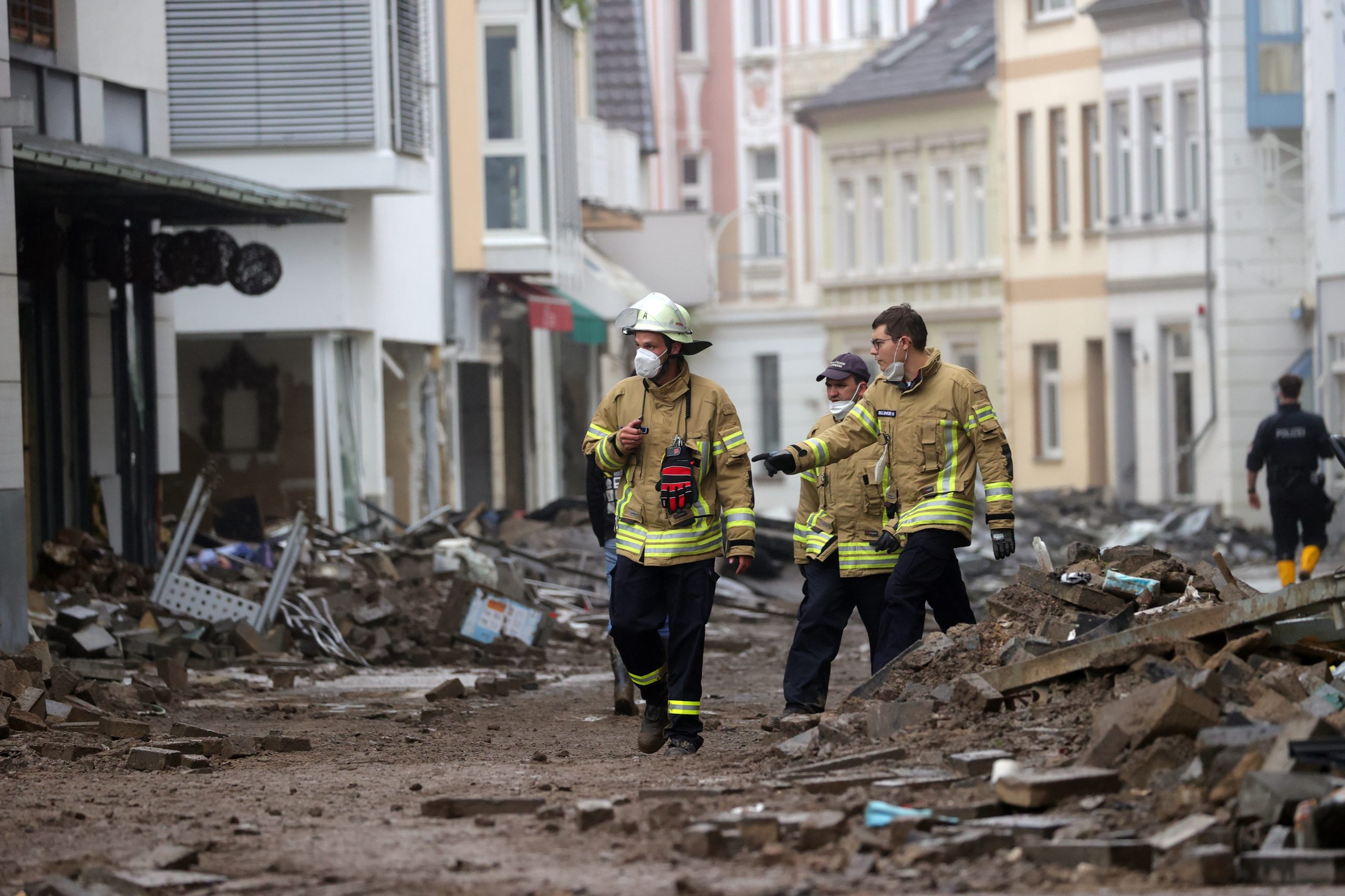 epa09347942 Members of the fire department (Feuerwehr) inspect a damaged area after flooding in Bad Neuenahr-Ahrweiler, Germany, 16 July 2021. Large parts of Western Germany were hit by heavy, continuous rain in the night to 15 July resulting in local flash floods that destroyed buildings and swept away cars.  EPA/FRIEDEMANN VOGEL