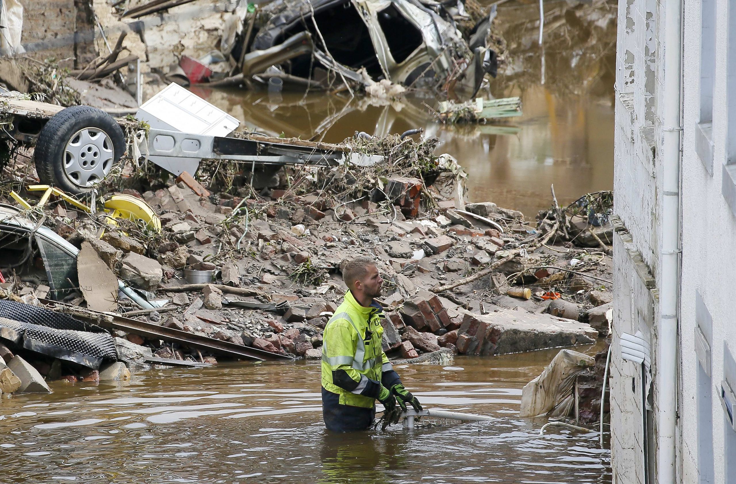epa09350108 Rescue forces among  the debris after heavy rains caused flooding in Pepinster, Belgium, 17 July 2021. Heavy rains have caused widespread damage and flooding in parts of Belgium.  EPA/JULIEN WARNAND