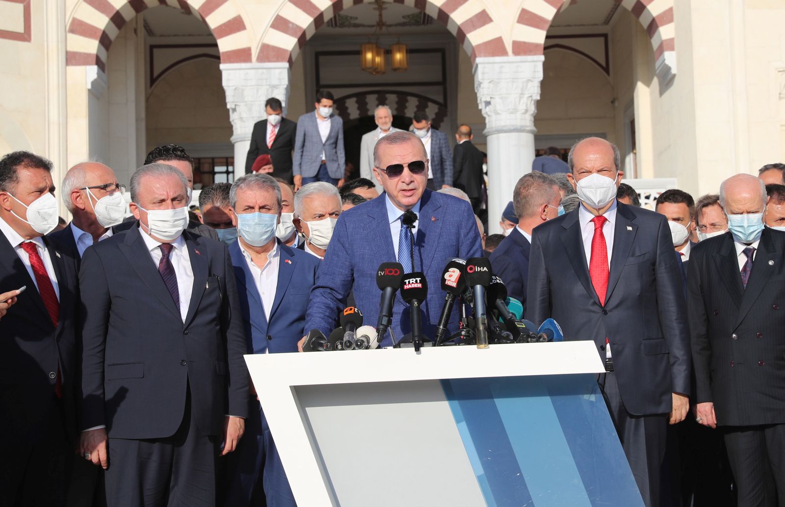 epa09354370 A handout picture provided by the Turkish President Press office shows Turkish President Recep Tayyip Erdogan (C) speaks with Turkish Cypriots President Ersin Tatar (C-R) after the Eid al-Adha prayers at the Hala Sultan Mosque in the Turkish-administered northern part of the divided capital Nicosia, Cyprus, 20 July 2021. Erdogan is in Northern Cyprus for celebrations of the 47th anniversary of the Turkey’s Peace Operation in Cyprus.  EPA/TURKISH PRESIDENT PRESS OFFICE HANDOUT HANDOUT  HANDOUT EDITORIAL USE ONLY/NO SALES