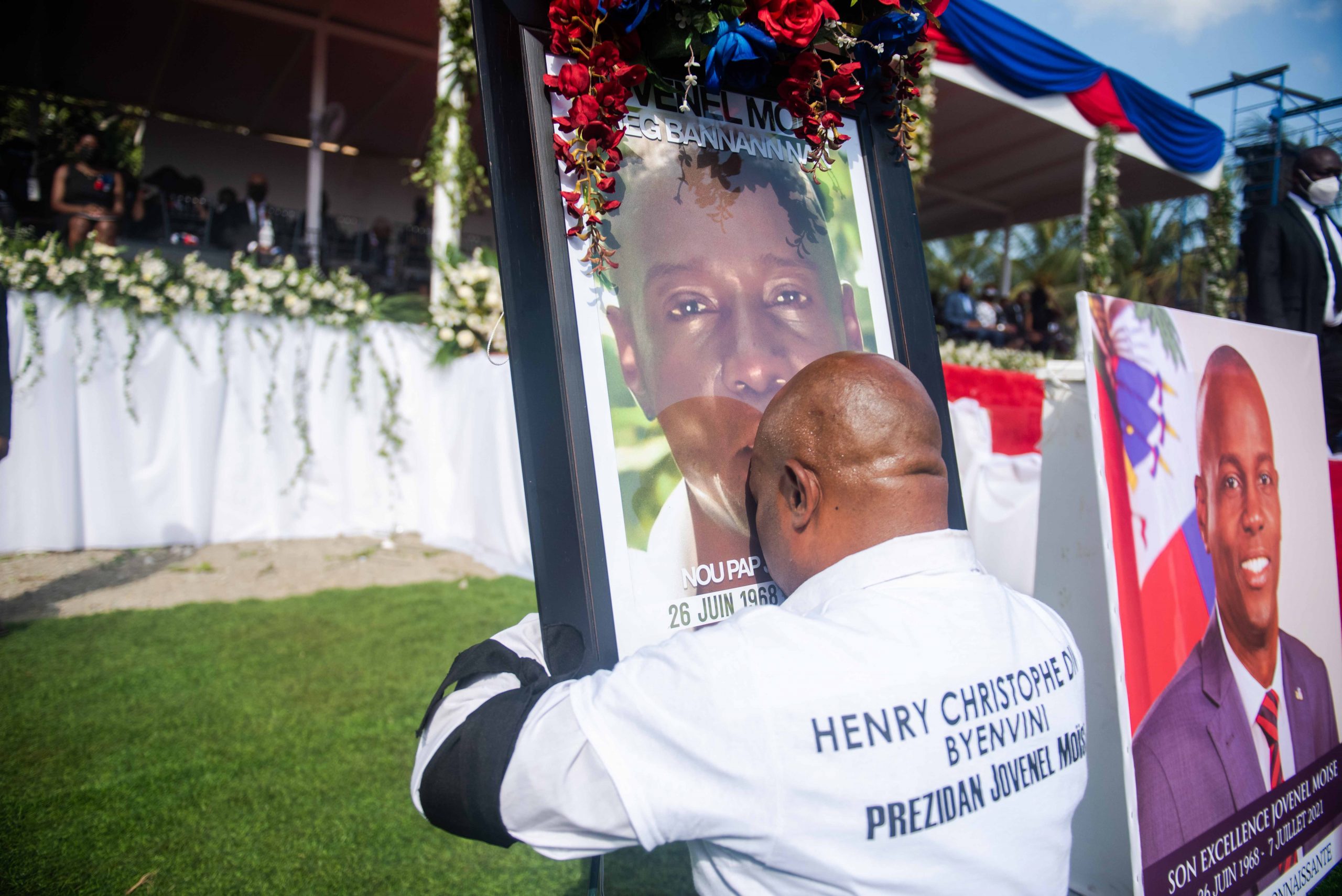 epa09360412 A man embraces a photograph with the image of President Jovenel Moise during his funeral ceremony in Cap-Haitien, Haiti, 23 July 2021. The wake in honor of the president of Haiti, Jovenel Moise, began this Friday in the city of Cap-Haitien, in the north of the country, hours before the burial of the president, who was murdered on July 7, takes place. The funeral service began two hours behind schedule and takes place in the gardens of the Habitation Village SOS, the Moise family's private residence on the outskirts of Cap-Haitien, which is guarded by a strong security apparatus.  EPA/Jean Marc Hervé Abélard