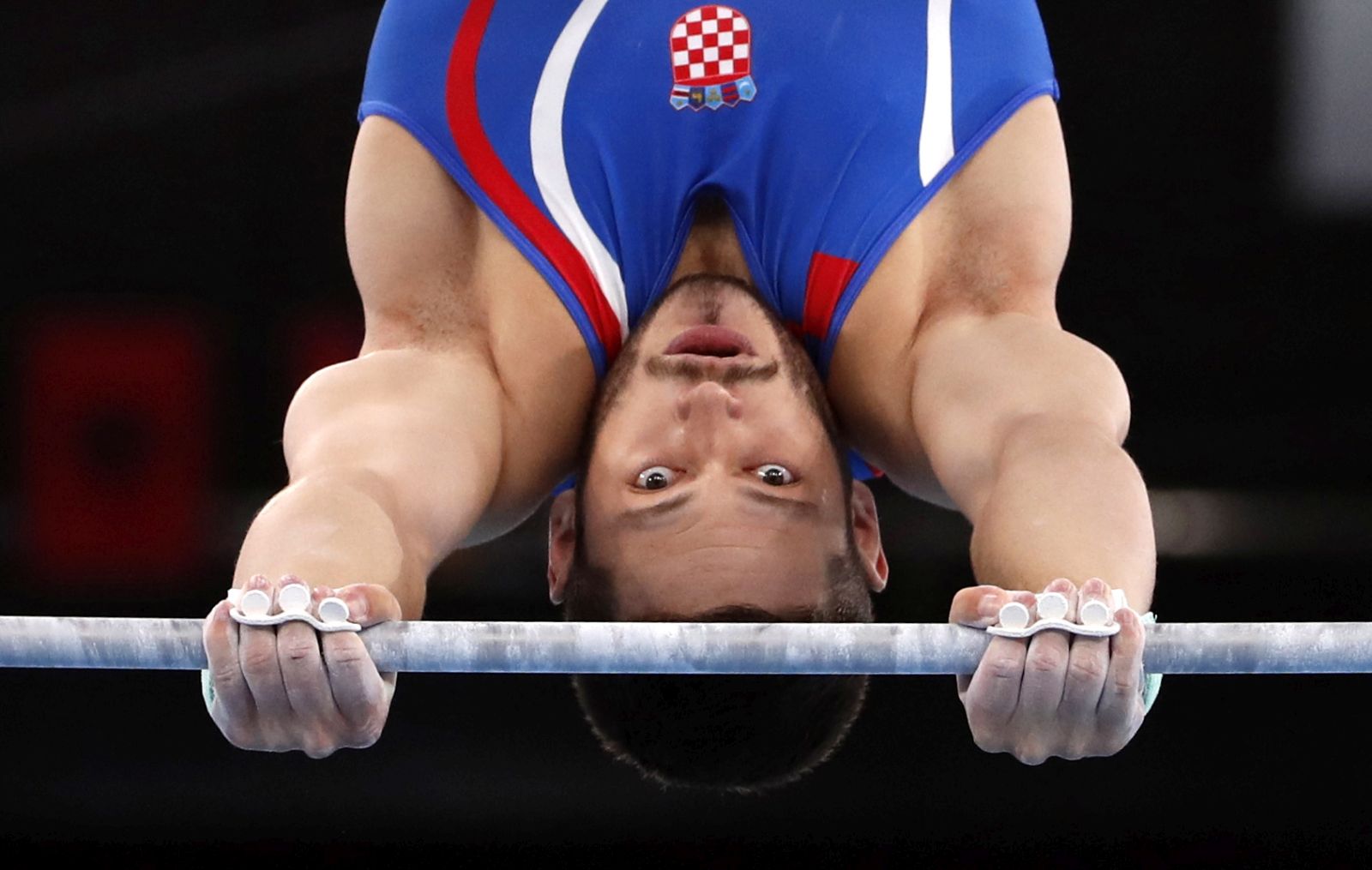 epa09360795 Tin Srbic of Croatia performs during the men's Horizontal Bar Qualification for the Tokyo 2020 Olympic Games at the Ariake Gymnastics Centre in Tokyo, Japan, 24 July 2021.  EPA/TATYANA ZENKOVICH