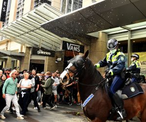 epaselect epa09360821 Protesters throw plastic bottles and pot plants at mounted police at Sydney Town Hall during the 'World Wide Rally For Freedom' anti-lockdown rally at Hyde Park in Sydney, New South Wales, Australia, 24 July 2021.  EPA/MICK TSIKAS AUSTRALIA AND NEW ZEALAND OUT
