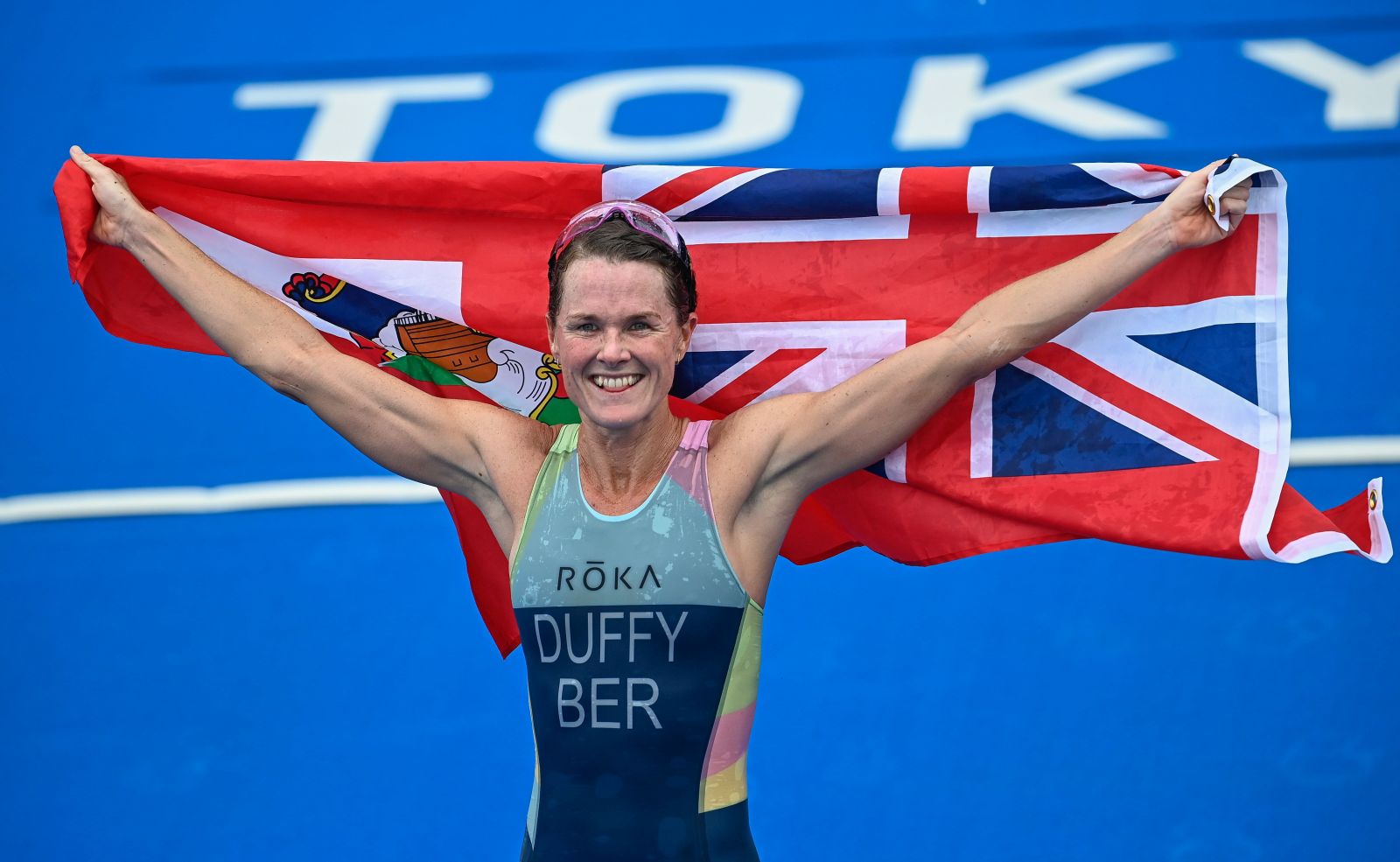 epa09368497 Flora Duffy of the Bermudas celebrates after she won the women's individual triathlon race of the Tokyo 2020 Olympic Games at the Odaiba Marine Park in Tokyo, Japan, 27 July 2021.  EPA/Zsolt Czegledi HUNGARY OUT