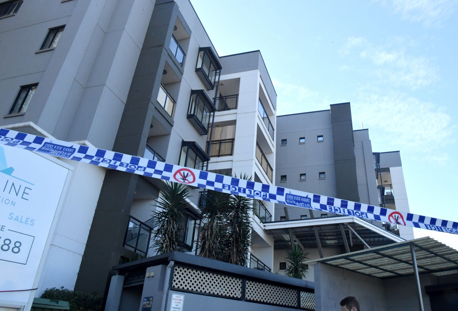 epa09371980 Police tape is seen at an apartment building that was put under lockdown at Devitt Street in the south western suburb of Blacktown in Sydney, Australia, 28 July 2021. NSW police are out guarding an apartment block in Devitt Street, Blacktown whose residents have been placed in isolation overnight. It's understood that health officials discovered several COVID-19 cases inside the building were linked, with fears that a super-spreading event may have occurred.  EPA/MICK TSIKAS  AUSTRALIA AND NEW ZEALAND OUT