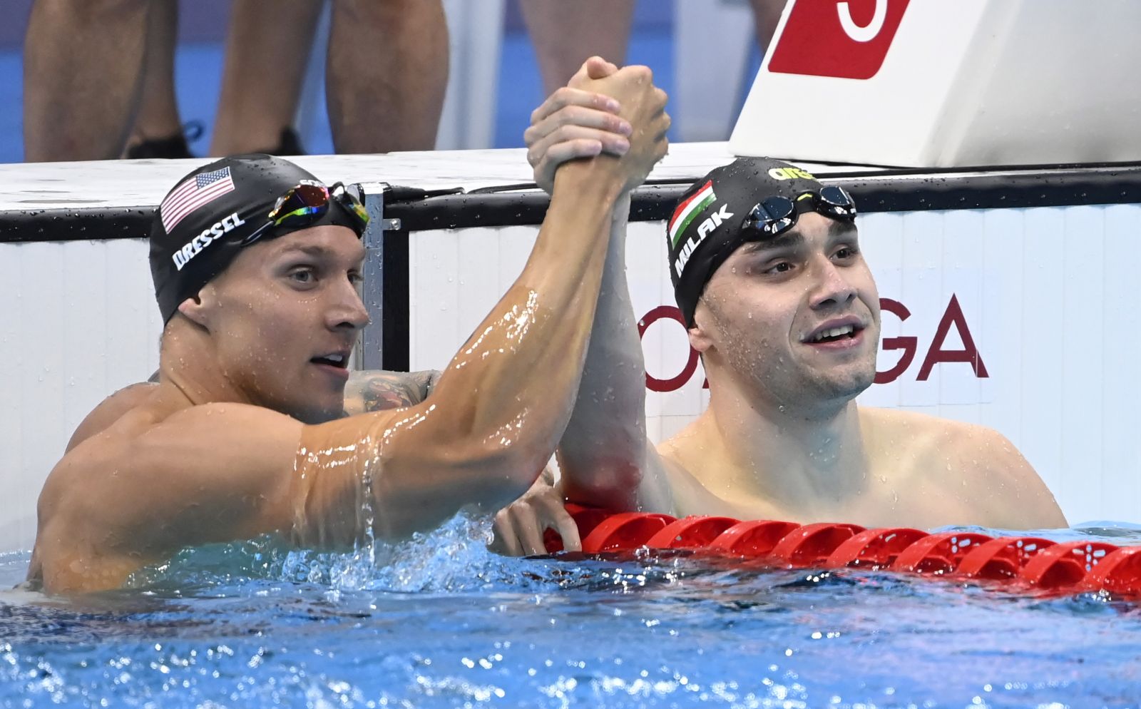 epa09381007 Gold medal winner Caeleb Dressel (L) of the USA and silver medal winner Kristof Milak (R) of Hungary celebrate after the final of men's 100m butterfly swimming event of the Tokyo 2020 Olympic Games at the Tokyo Aquatics Centre in Tokyo, Japan, 31 July 2021.  EPA/Tamas Kovacs HUNGARY OUT