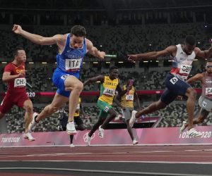 Filippo Tortu, of Italy, crosses the finish line ahead of Nethaneel Mitchell-Blake, of Britain, to lead his to team a gold medal in the men's 4x100-meter relay at the 2020 Summer Olympics, Friday, Aug. 6, 2021, in Tokyo. (AP Photo/David J. Phillip)