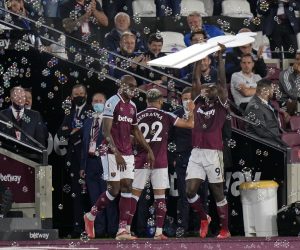 West Ham's Michail Antonio, right, holds aloft a cardboard cutout of himself as he celebrates after scoring his side's third goal during the English Premier League soccer match between West Ham United and Leicester City and at the London Stadium in London, Monday, Aug. 23, 2021. (AP Photo/Alastair Grant)