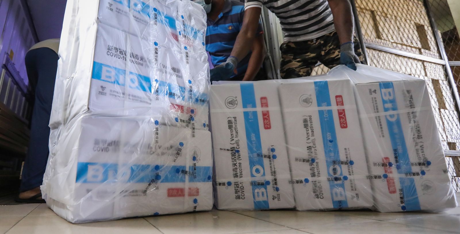 epa09369293 Sri Lankan workers unload a newly arrived shipment of the Chinese Sinopharm Covid-19 vaccine at the Medical Supplies Division in Colombo, Sri Lanka, 27  July 2021. According to the health ministry, the Chinese government donated 1.6 million doses of the Chinese Sinopharm Covid-19 vaccine to Sri Lanka on 27 July 2021. Sri Lanka is currently using Oxford AstraZeneca, China's Sinopharm, Russian Sputnik V, and Moderna Covid -19 vaccines for the Vaccine rollout.  EPA/CHAMILA KARUNARATHNE