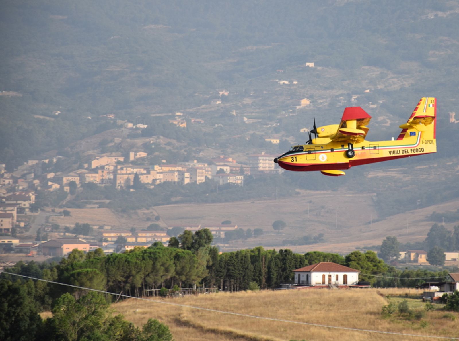 epa09379693 A handout photo made available by Vigili del Fuoco (VVF), the Italian National Fire Brigade, shows a canadair water bomber aircraft of the Vigili del Fuoco conducting extinguishing operations of a forest fire affecting an area between Piana degli Albanesi and Altofonte, near Palermo, Sicily Island, southern Italy, 30 July 2021. Since 29 July evening emergency teams worked to counter the numerous flame fronts, fueled by strong winds and high temperatures, that have devastated the Palermo area.  EPA/VIGILI DEL FUOCO HANDOUT -- BEST QUALITY AVAILABLE -- HANDOUT EDITORIAL USE ONLY/NO SALES