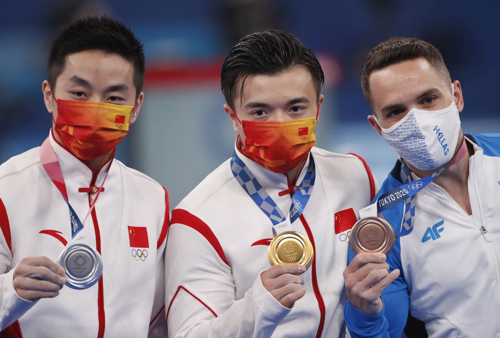 epa09387487 L-R: Silver medal winner Hao You of China, gold medal winner Yang Liu of China and bronze medal winner Eleftherios Petrounias of Greece pose on the podium during the medal ceremony for the Men's Ring Final during the Artistic Gymnastics events of the Tokyo 2020 Olympic Games at the Ariake Gymnastics Centre in Tokyo, Japan, 02 August 2021.  EPA/TATYANA ZENKOVICH