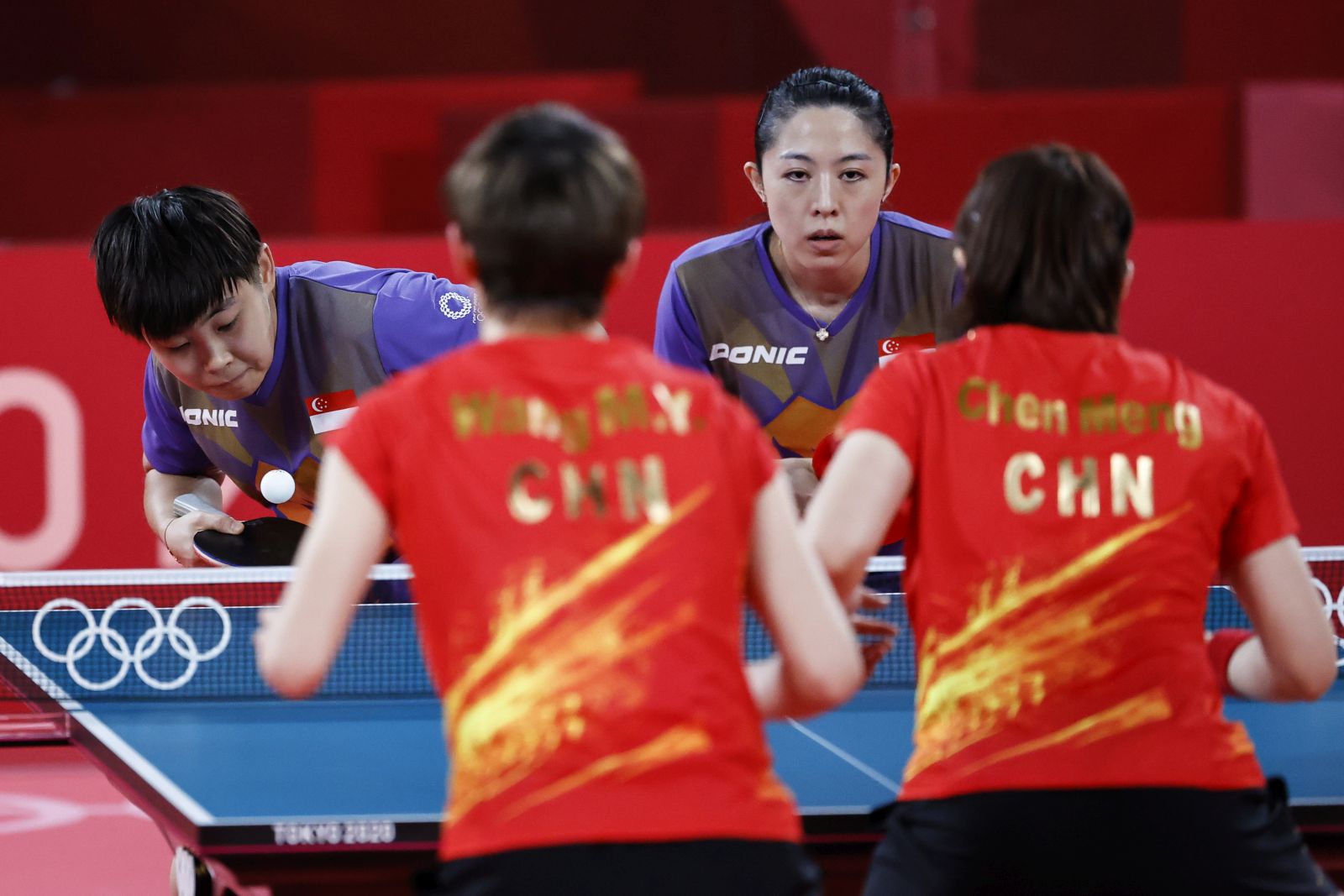epa09390160 Ye Lin (L) and Mengyu Yu (2-R) of Singapore in action against Manyu Wang and Meng Chen of China during the women's team quarterfinal table tennis match at the Tokyo 2020 Olympic Games at the Tokyo Metropolitan Gymnasium arena in Tokyo, Japan, 03 August 2021.  EPA/MAST IRHAM