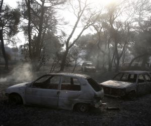 epa09393646 Burnt cars are seen after a wildfire in the area of Varybobi, northeastern suburb of Athens, Greece, 04 August 2021. The major fire that broke out in the wildland-urban interface in Varybobi on 03 August 2021 was still burning, despite the efforts of strong fire-fighting forces through the night. Reinforcements have been sent from areas throughout the country to help put out the blaze, while five fire-fighting aircraft and nine helicopters resumed operations at first light.  EPA/YANNIS KOLESIDIS