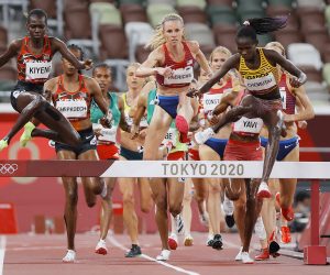 epa09394332 Peruth Chemutai (R) of Uganda on her way winning the Women's 3000m Steeplechase final during the Athletics events of the Tokyo 2020 Olympic Games at the Olympic Stadium in Tokyo, Japan, 04 August 2021.  EPA/VALDRIN XHEMAJ