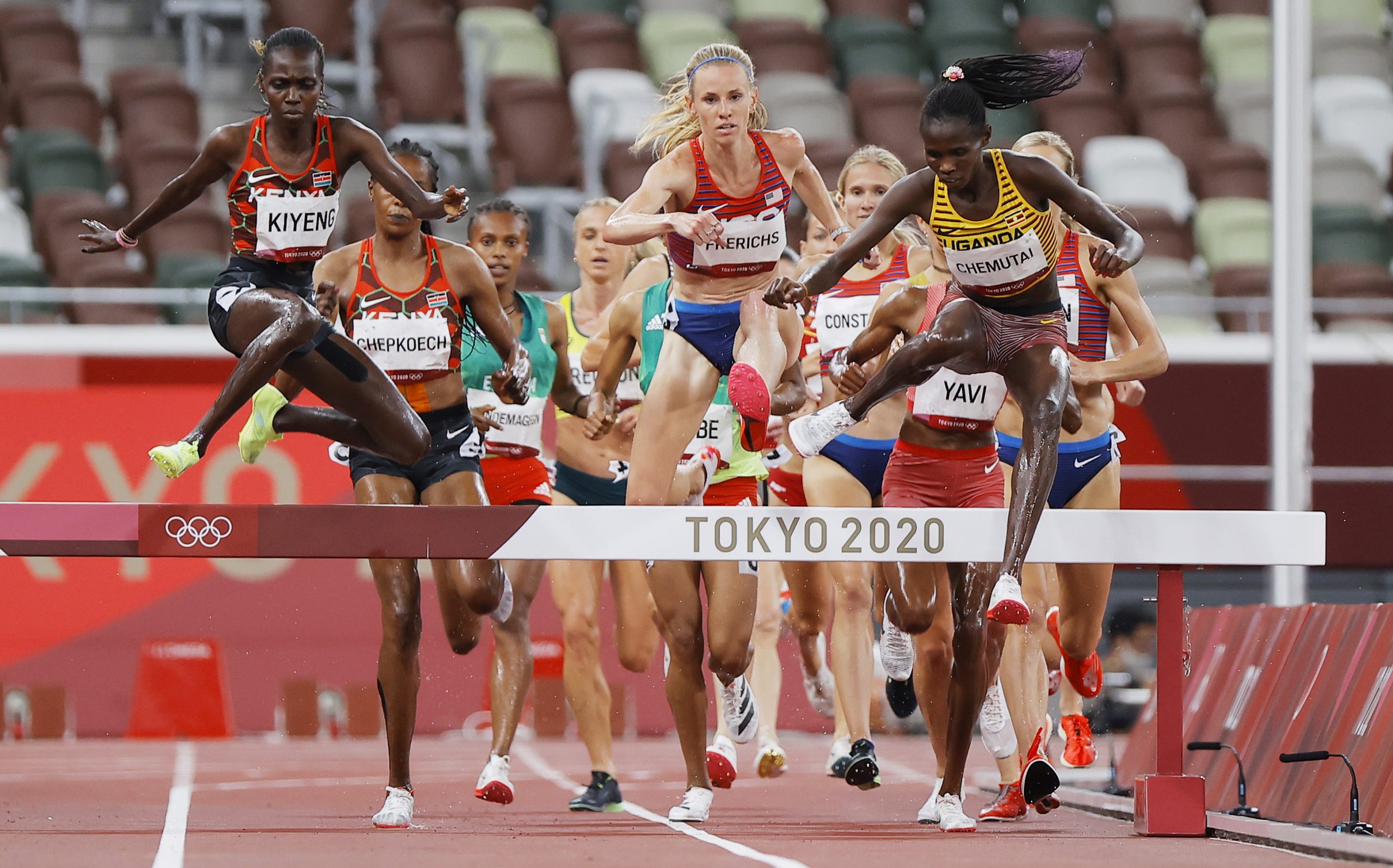 epa09394332 Peruth Chemutai (R) of Uganda on her way winning the Women's 3000m Steeplechase final during the Athletics events of the Tokyo 2020 Olympic Games at the Olympic Stadium in Tokyo, Japan, 04 August 2021.  EPA/VALDRIN XHEMAJ