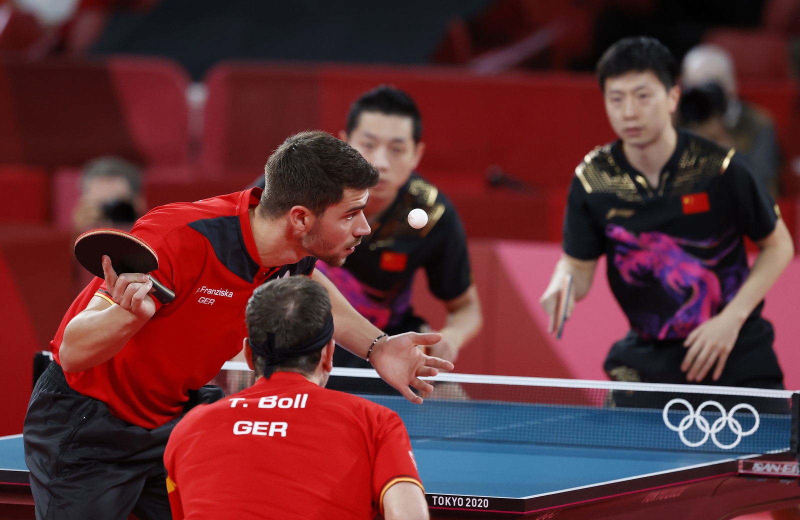 epa09400193 Timo Boll (R) und Patrick Franziska (R) of Germany in action during the Table Tennis men's team cold medal match against Ma Long and Xu Xin of China during the Tokyo 2020 Olympic Games at the Tokyo Metropolitan Gymnasium arena in Tokyo, Japan, 06 August 2021.  EPA/MAST IRHAM