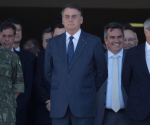 epa09408393 Brazilian President Jair Bolsonaro (C) watches the military convoy pass in front of the Planalto Palace at the main entrance of the Esplanada do Ministerios, in Brasilia, Brazil, 10 August 2021. The president of Brazil, Jair Bolsonaro, received an unusual military parade in Brasilia on 10 August, a display that was seen by the opposition as an attempt by the leader of the Brazilian far-right to intimidate Congress during a key vote for the Government, and that was praised by dozens of supporters who came out to see the event and take pictures of the military equipment.  EPA/Joedson Alves