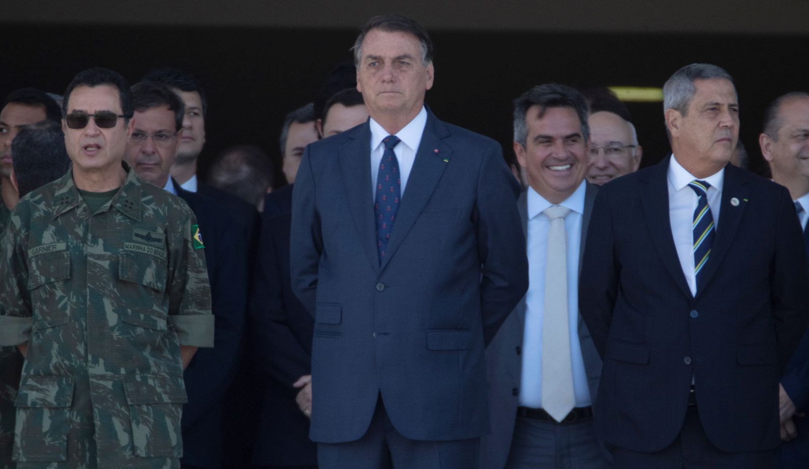 epa09408393 Brazilian President Jair Bolsonaro (C) watches the military convoy pass in front of the Planalto Palace at the main entrance of the Esplanada do Ministerios, in Brasilia, Brazil, 10 August 2021. The president of Brazil, Jair Bolsonaro, received an unusual military parade in Brasilia on 10 August, a display that was seen by the opposition as an attempt by the leader of the Brazilian far-right to intimidate Congress during a key vote for the Government, and that was praised by dozens of supporters who came out to see the event and take pictures of the military equipment.  EPA/Joedson Alves