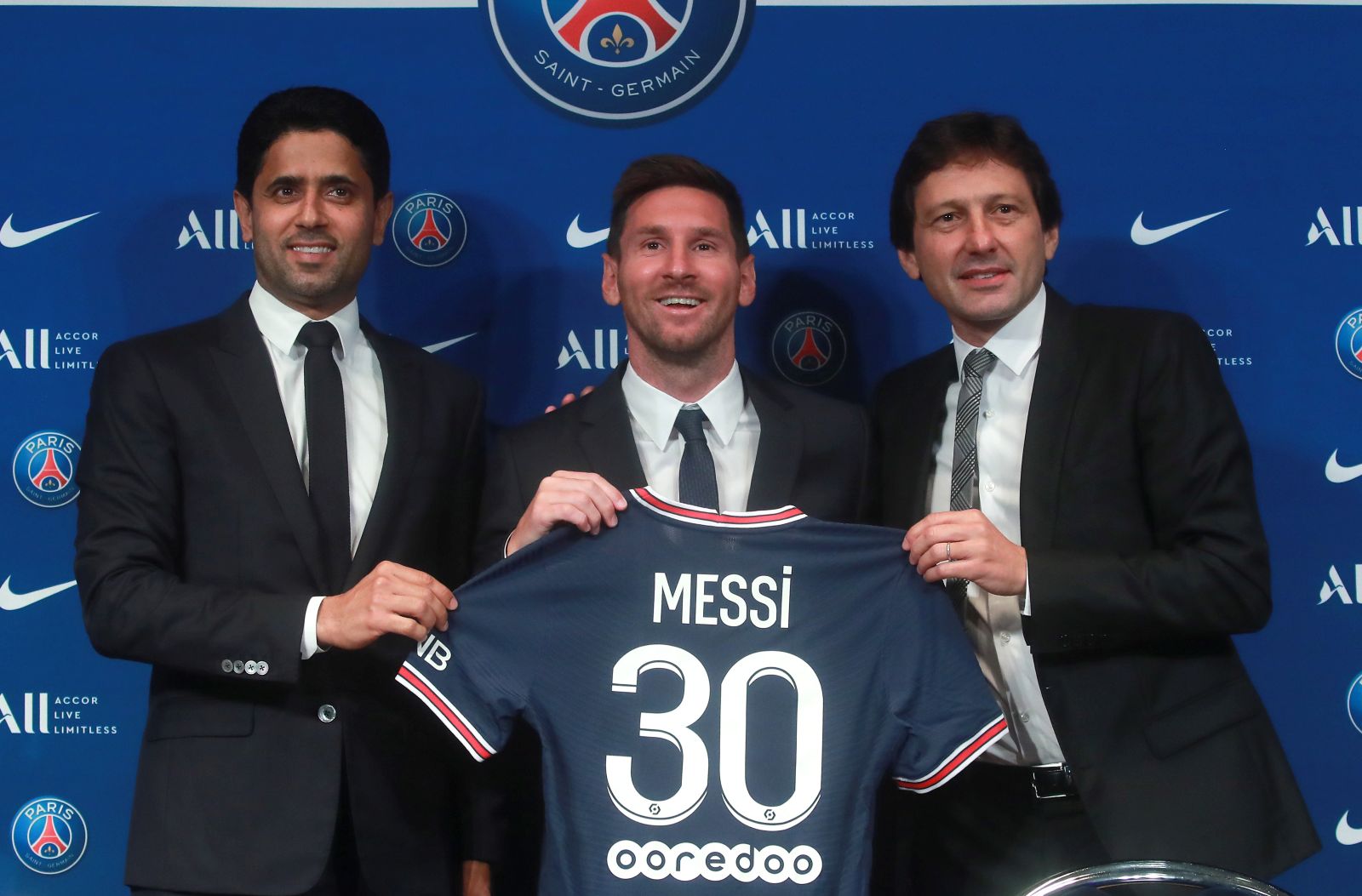 epa09409490 Paris Saint-Germain's president Nasser Al-Khelaifi (L), sports director Leonardo (R) and Argentinian striker Lionel Messi (C) pose with his new PSG jersey after his press conference as part of his official presentation at the Parc des Princes stadium, in Paris, France, 11 August 2021. Messi arrived in Paris on 09 August and signed a contract with French soccer club Paris Saint-Germain.  EPA/CHRISTOPHE PETIT TESSON