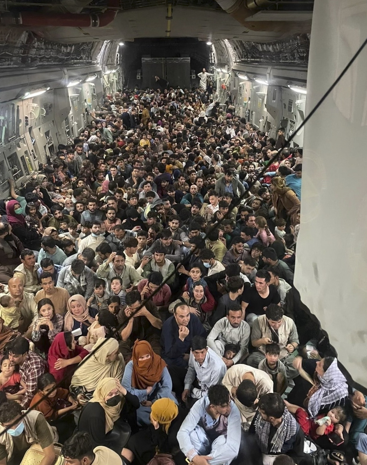 epa09417900 A picture made available on 17 August 2021 shows approximately 640 Afghan citizens being evacuated on an United States Air Force C-17 Globemaster III airplane from Hamid Karzai International Airport 15 August 2021 in Kabul, Afghanistan. The United States military has been working to evacuate US citizens and some Afghan citizens after the Taliban took over Afghanistan as the US pulled out of the country.  EPA/AIR MOBILITY COMMAND PUBLIC AFFAIRS HANDOUT  HANDOUT EDITORIAL USE ONLY/NO SALES