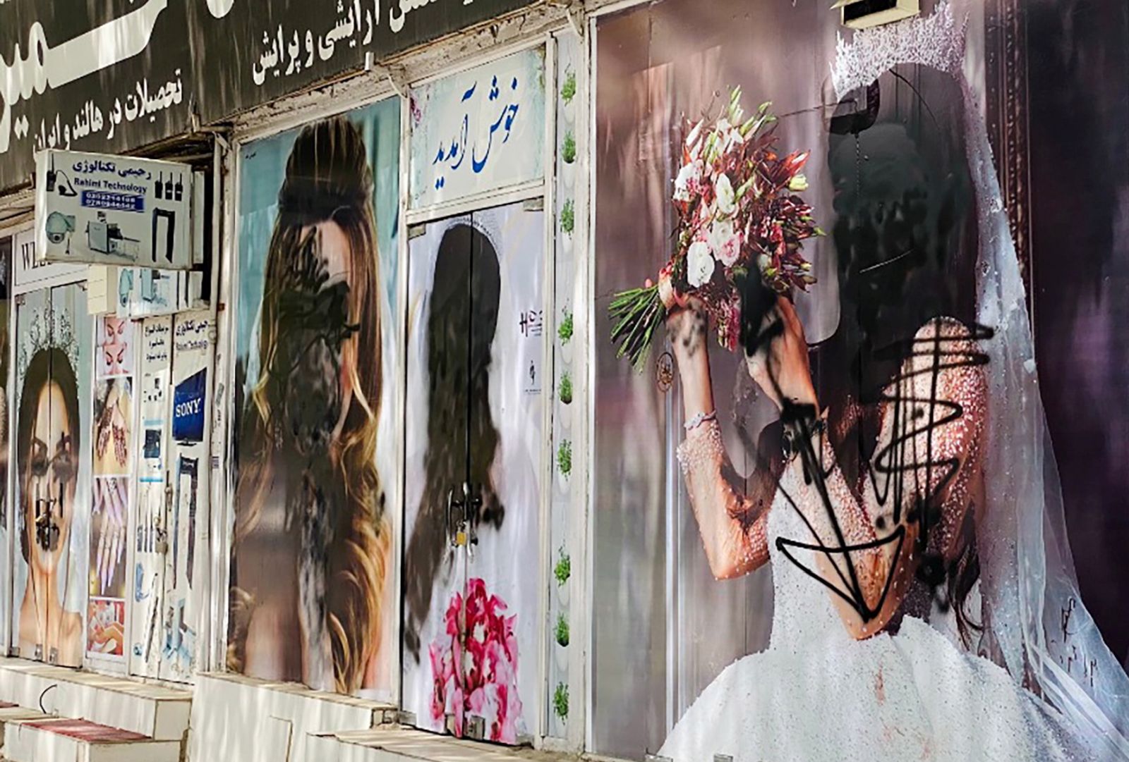 epa09421708 A view of the defaced posters of models on the walls of a beauty saloon in Kabul, Afghanistan, 20 August 2021. The Afghan interim council, formed to assist in the power transfer following President Ashraf Ghani's escape, has met several Taliban leaders to discuss issues related to control and security during the transition process. Fighting and violence have significantly reduced in Afghanistan with the surrender of the government troops and the resounding victory of the Taliban.  EPA/STRINGER
