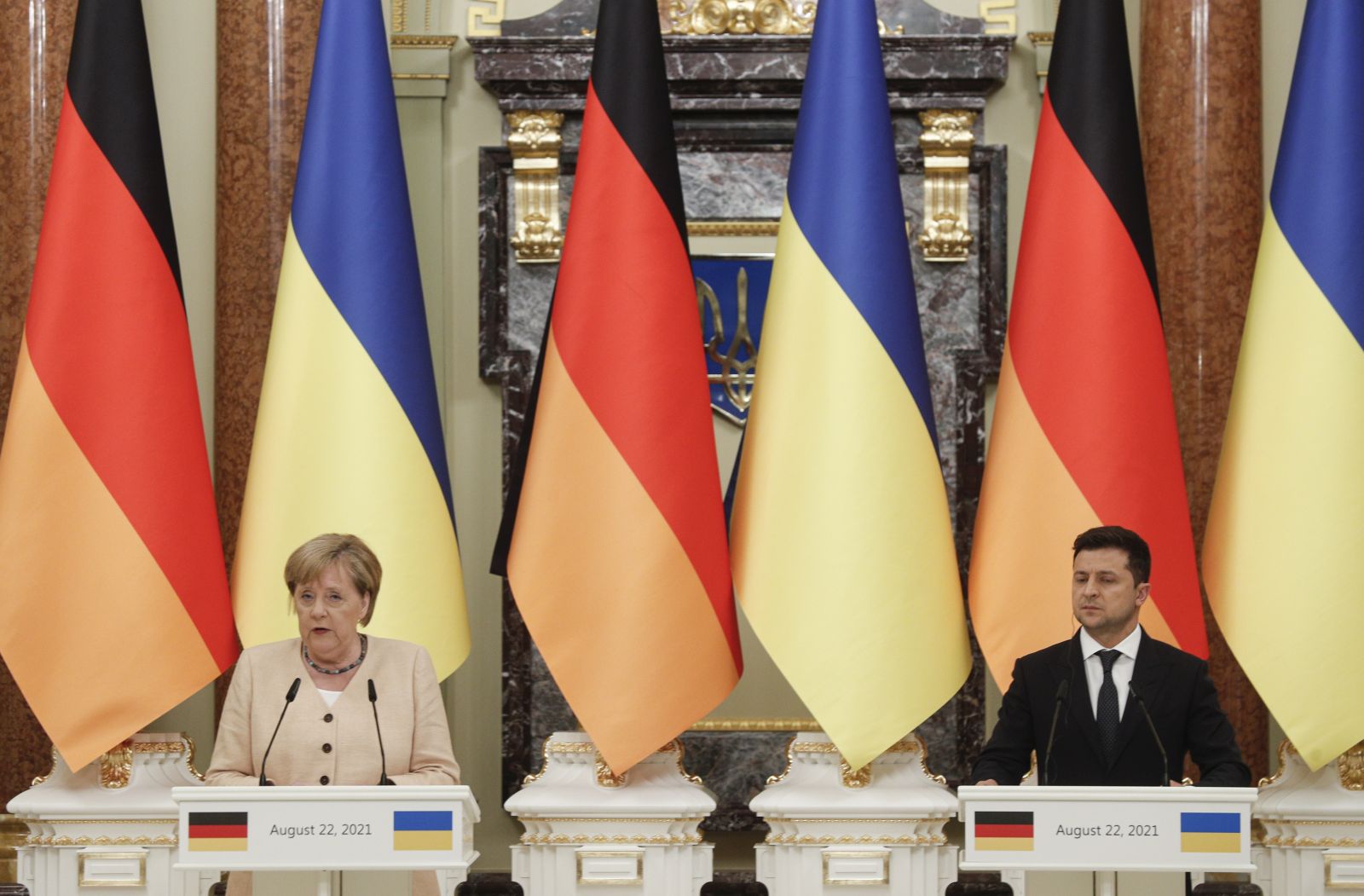 epa09424586 German Chancellor Angela Merkel (L) and Ukrainian President Volodymyr Zelensky (R) attend a joint news conference following their talks at the Mariinsky Palace in Kiev, Ukraine, 22 August 2021. Merkel arrived in Kiev for a working visit to meet with top Ukrainian officials.  EPA/SERGEY DOLZHENKO / POOL