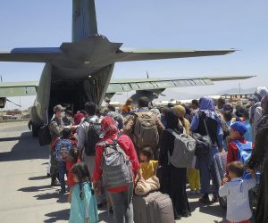 epa09429709 A handout photo made available by the Republic of Korea Air Force shows some 380 Afghans who have worked for South Koreans in their war-ravaged nation and their family members boarding a South Korea military plane at an airport in Kabul, Afghanistan, 25 August 2021, to head for South Korea.  EPA/REPUBLIC OF KOREA AIR FORCE / HANDOUT SOUTH KOREA OUT 
ATTENTION EDITORS: IMAGE PIXELATED AT SOURCE HANDOUT EDITORIAL USE ONLY/NO SALES