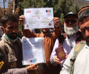 epa09430511 Afghans hold documents as they struggle to reach the foreign forces to show their credentials to flee the country outside the Hamid Karzai International Airport, in Kabul, Afghanistan, 26 August 2021. At least 13 people including children were killed in a blast outside the airport on 26 August. The blast occurred outside the Abbey Gate and follows recent security warnings of attacks ahead of the 31 August deadline for US troops withdrawal.  EPA/AKHTER GULFAM