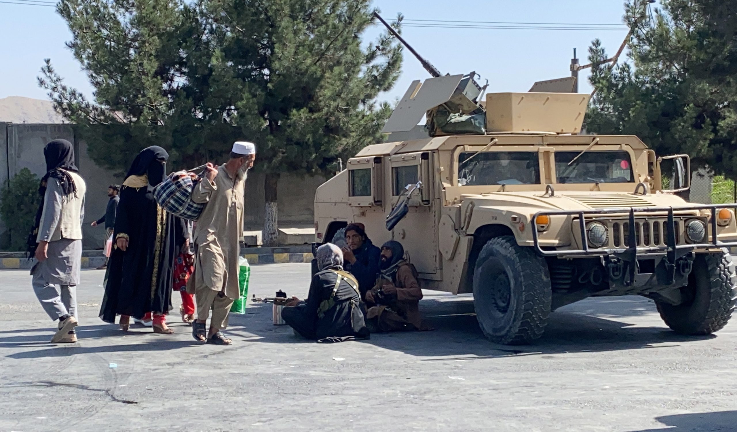 epa09431752 Taliban stand guard as they block the road to Hamid Karzai Airport a day after deadly blasts, in Kabul, Afghanistan, 27 August 2021. Two explosions outside Kabul's international airport on 26 August left more than 60 Afghan civilians dead and 140 others wounded, while the United States military said that 12 of its personnel died.  EPA/STRINGER