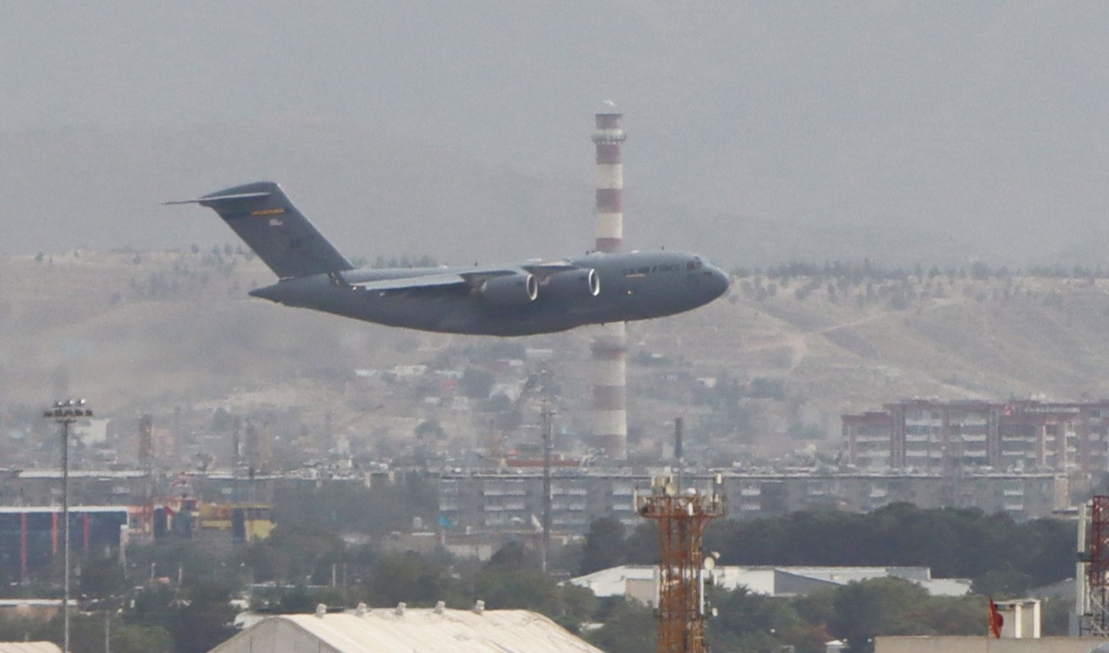epa09436853 A Military aircraft takes off at the Hamid Karzai International Airport in Kabul, Afghanistan, 30 August 2021. Multiple explosions rocked the capital city of Kabul on 30 August, a day before the final withdrawal of foreign troops from Afghanistan.  EPA/STRINGER