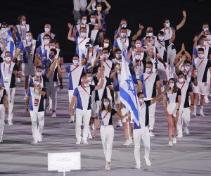 Israel's delegation members attend the Parade of Athletes during the Opening Ceremony of the Tokyo 2020 Olympic Games at National Stadium in Tokyo on July 23rd, 2021. Eleven thousand people coming from two hundred six countries and regions will participate in the event.( The Yomiuri Shimbun via AP Images )