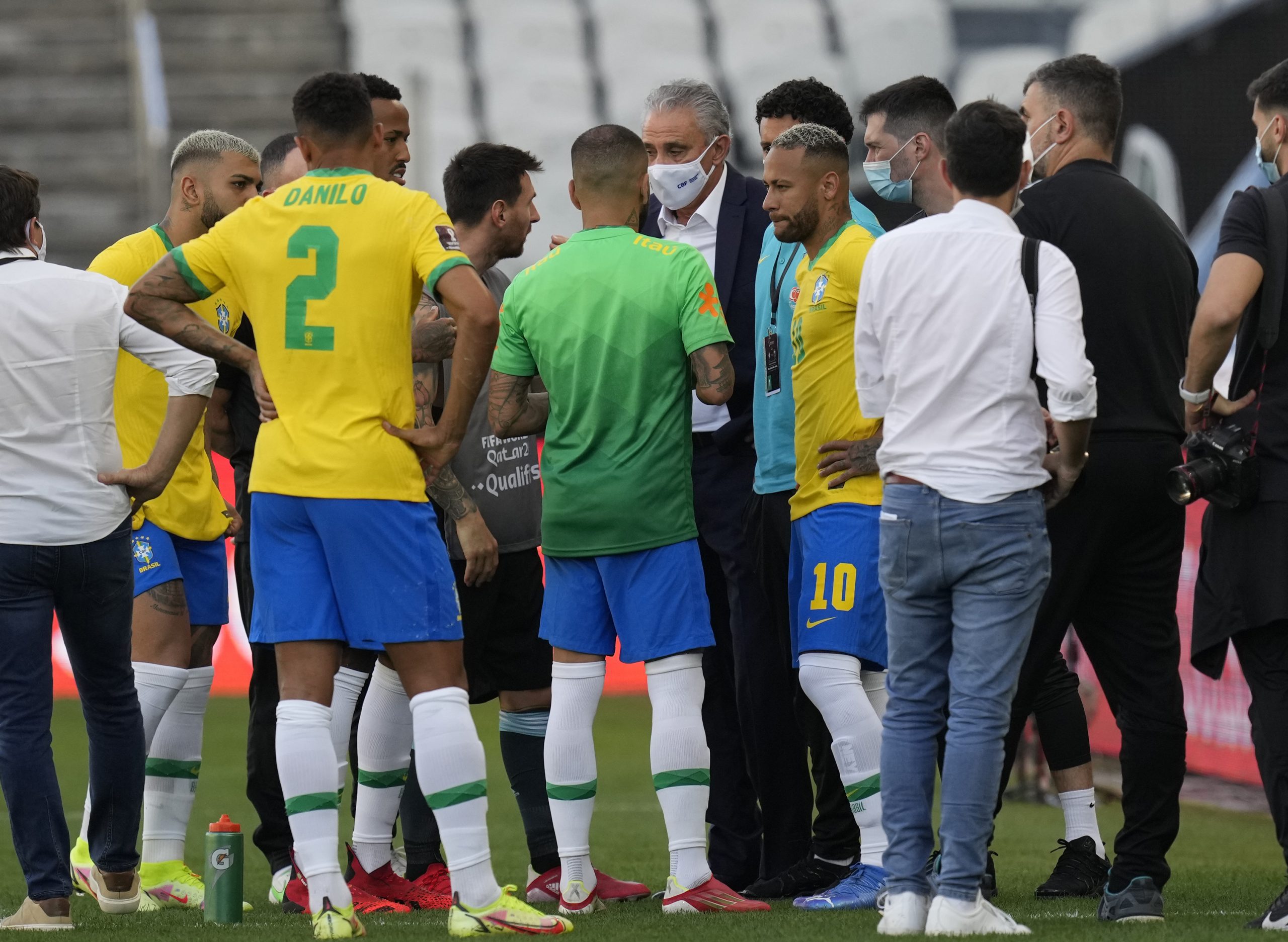 Brazil's coach Tite talks with Argentina's Lionel Messi and Brazil's Neymar as the soccer game is interrupted by health authorities during a qualifying soccer match for the FIFA World Cup Qatar 2022 at Neo Quimica Arena stadium in Sao Paulo, Brazil, Sunday, Sept.5, 2021. Federal police and health agency officers interrupted the South American classic between the Brazilian and Argentine soccer teams after six minutes of play, in an operation that investigates the irregular entry of four players of Argentina into the country. (AP Photo/Andre Penner)