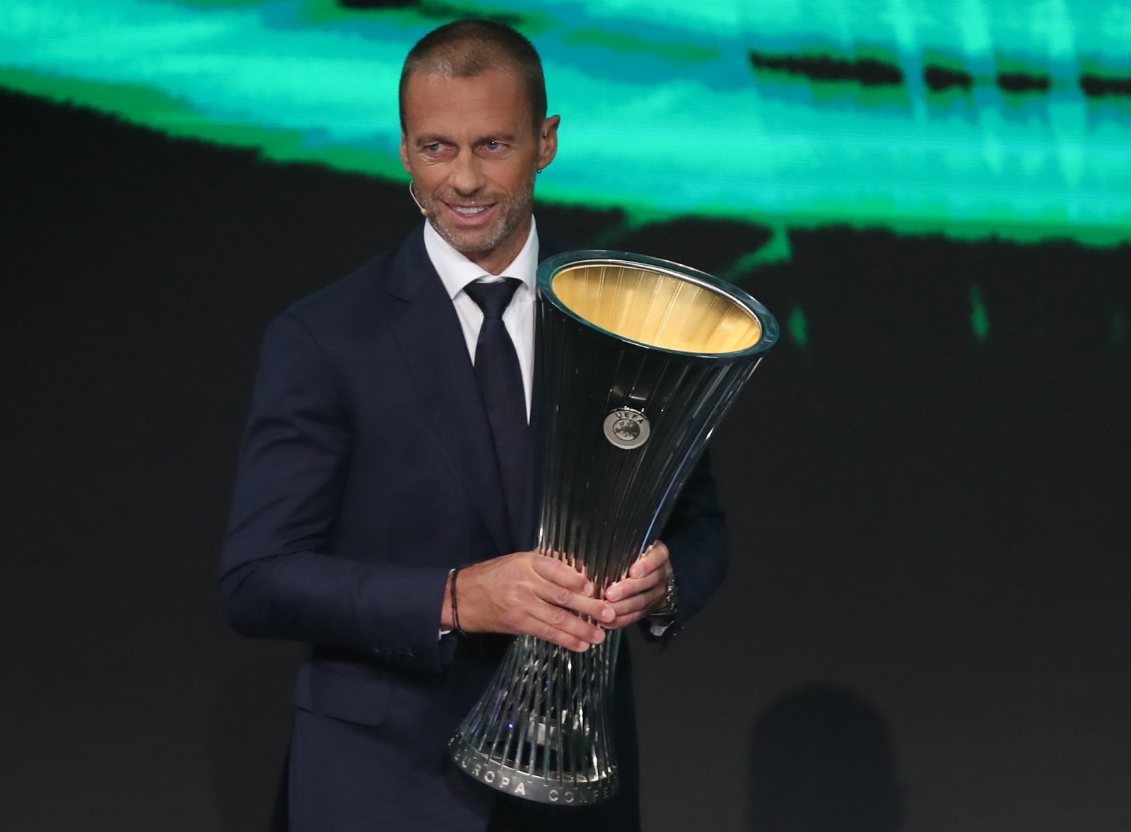 epa09431999 UEFA president Aleksander Ceferin carries the UEFA Europa Conference League trophy the UEFA Draw and Awards Ceremony at the Halic Congress Center in Istanbul, Turkey, 27 August 2021.  EPA/TOLGA BOZOGLU