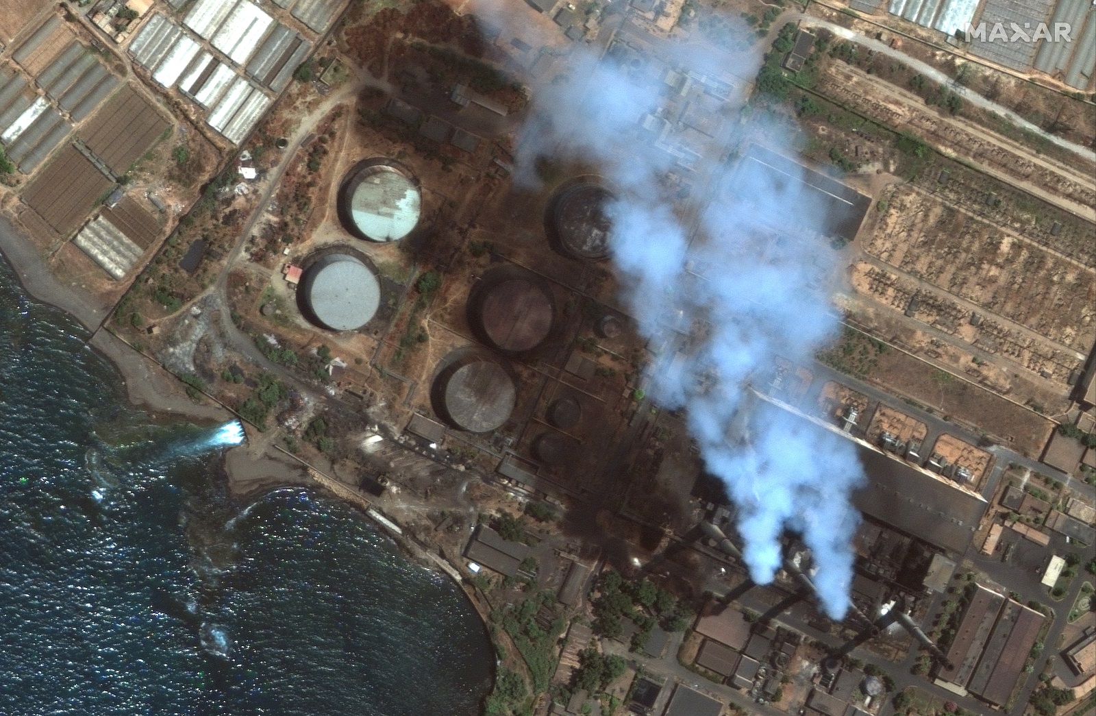 epa09439907 A handout satellite image made available by Maxar Technologies shows oil tanks at the Baniyas power plant before rupture, in Baniyas, Syria, 27 July 2021 (issued 01 September 2021). An oil spill is spreading across the Mediterranean and the Syrian coast toward Cyprus.  EPA/MAXAR TECHNOLOGIES HANDOUT -- MANDATORY CREDIT: SATELLITE IMAGE 2021 MAXAR TECHNOLOGIES -- the watermark may not be removed/cropped -- HANDOUT EDITORIAL USE ONLY/NO SALES