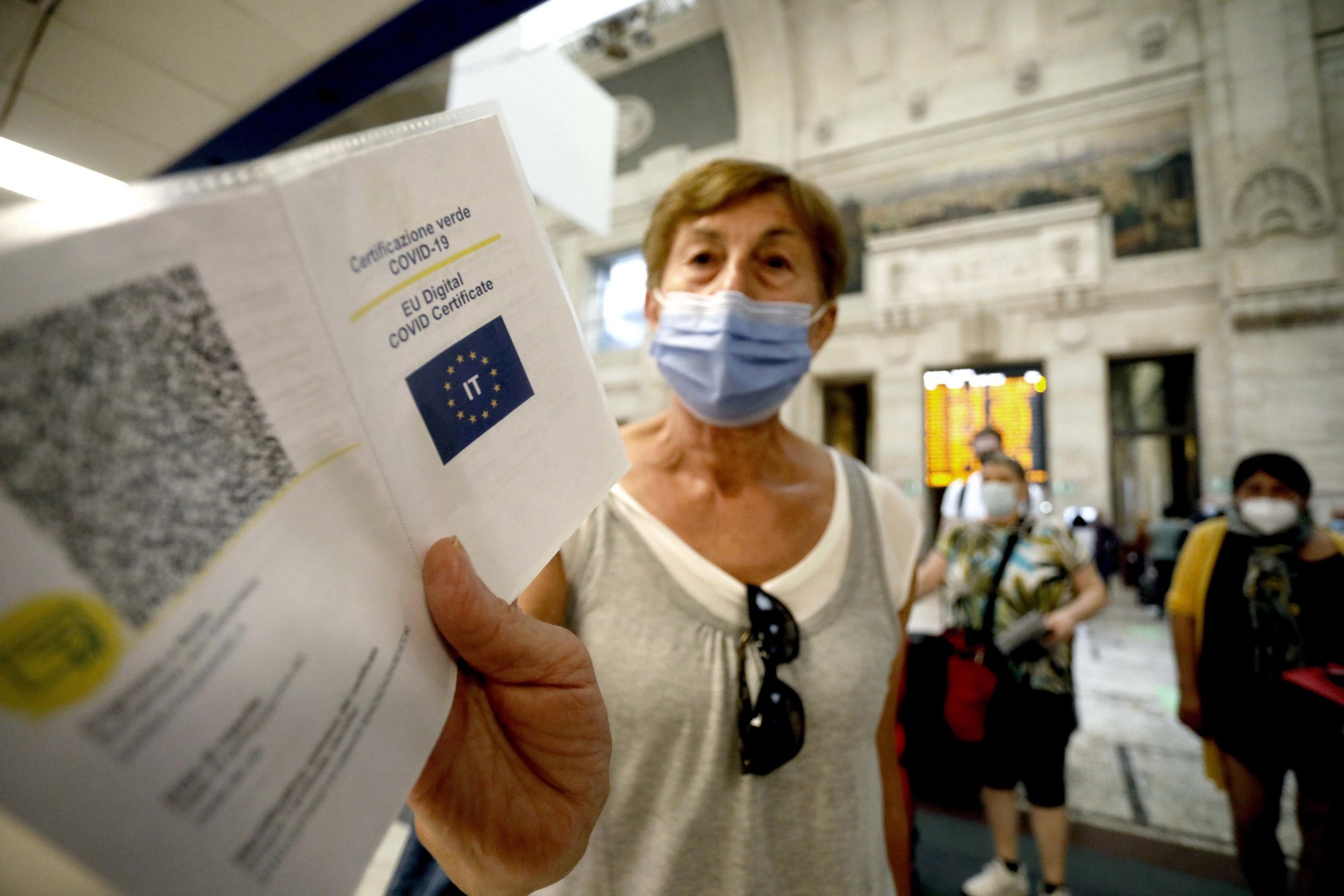 epa09440080 Green Pass vaccine passports of passengers departing from the Central Station are checked, in Milan, Italy, 01 September 2021. Starting from today Italy's Green Pass vaccine passport is obligatory for long-distance trains, domestic air flights and schools amid widespread misgivings.  EPA/Mourad Balti Touati