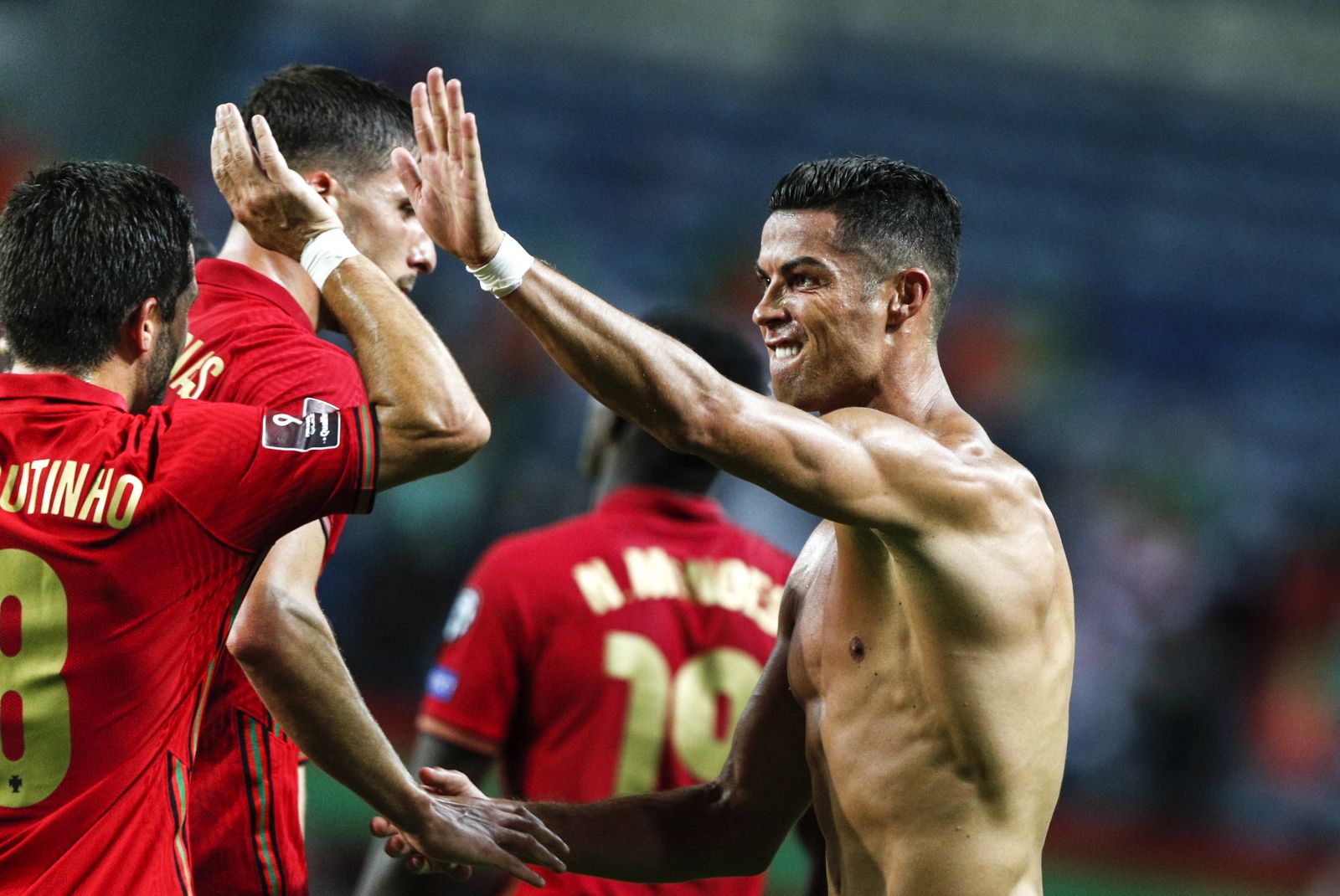 epa09441734 Cristiano Ronaldo (R) of Portugal celebrates after scoring a goal during the FIFA World Cup Qatar 2022 group A qualification soccer match between Portugal and Ireland held at Algarve stadium in Faro, Portugal, 01 September  2021.  EPA/ANTONIO COTRIM