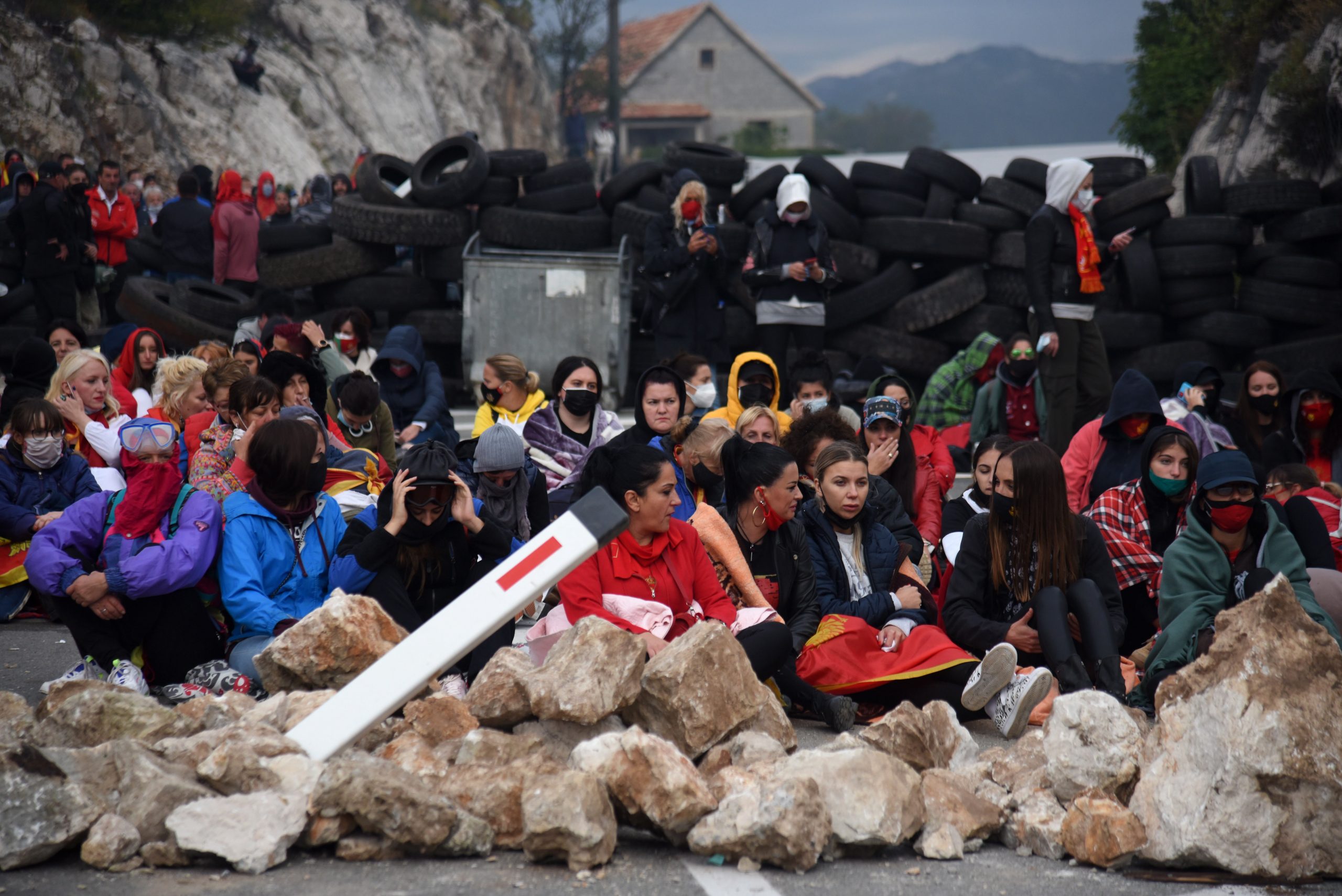 epa09448742 Demonstrators sit at a barricade during a protest against the enthronement of the Serbian Orthodox bishop in Cetinje, Montenegro, 05 September 2021. The enthronement of the new bishop of the Serbian Orthodox Church in Montenegro is causing a divide in Montenegro, sparking tensions between the members of the Serbian orthodox church and protestors who are opposing the ceremony taking place in the former Montenegrin royal capital.  EPA/BORIS PEJOVIC