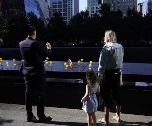epa09459965 Members of the public pay their respects at the 9/11 Memorial in New York, New York, USA, 10 September 2021. The 20th anniversary of the worst terrorist attack on US soil will be observed on 11 September 2021.  EPA/WILL OLIVER