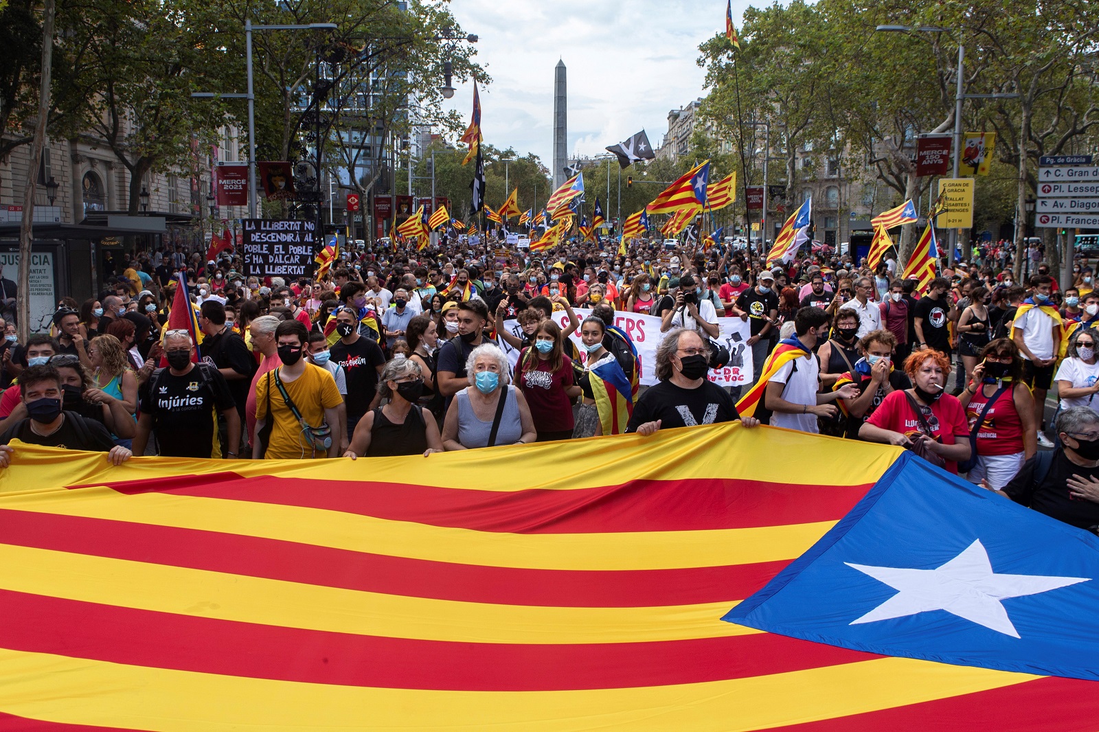 epa09461477 A big pro-independence flag is seen during a demonstration organized by CDR on occasion of the Day of Catalonia, 'Diada', in Barcelona, Catalonia, Spain, 11 September 2021. The Diada is celebrated annually on 11 September and marks the fall of Barcelona during the War of the Spanish Succession in 1714.  EPA/Enric Fontcuberta