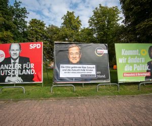 epa09473026 Large election placards of the three leading candidates in the German federal elections (L-R) Olaf Scholz of the Social Democratic Party (SPD), Armin Laschet of the Christian Democratic Union (CDU) and Annalena Baerbock of the Green Party (Buendnis 90/Die Gruenen) in Frankfurt am Main, Germany, 17 September 2021. An anti-CDU sticker was posted on the placard showing Laschet. Germany will hold general elections oon 26 September 2021.  EPA/Constantin Zinn