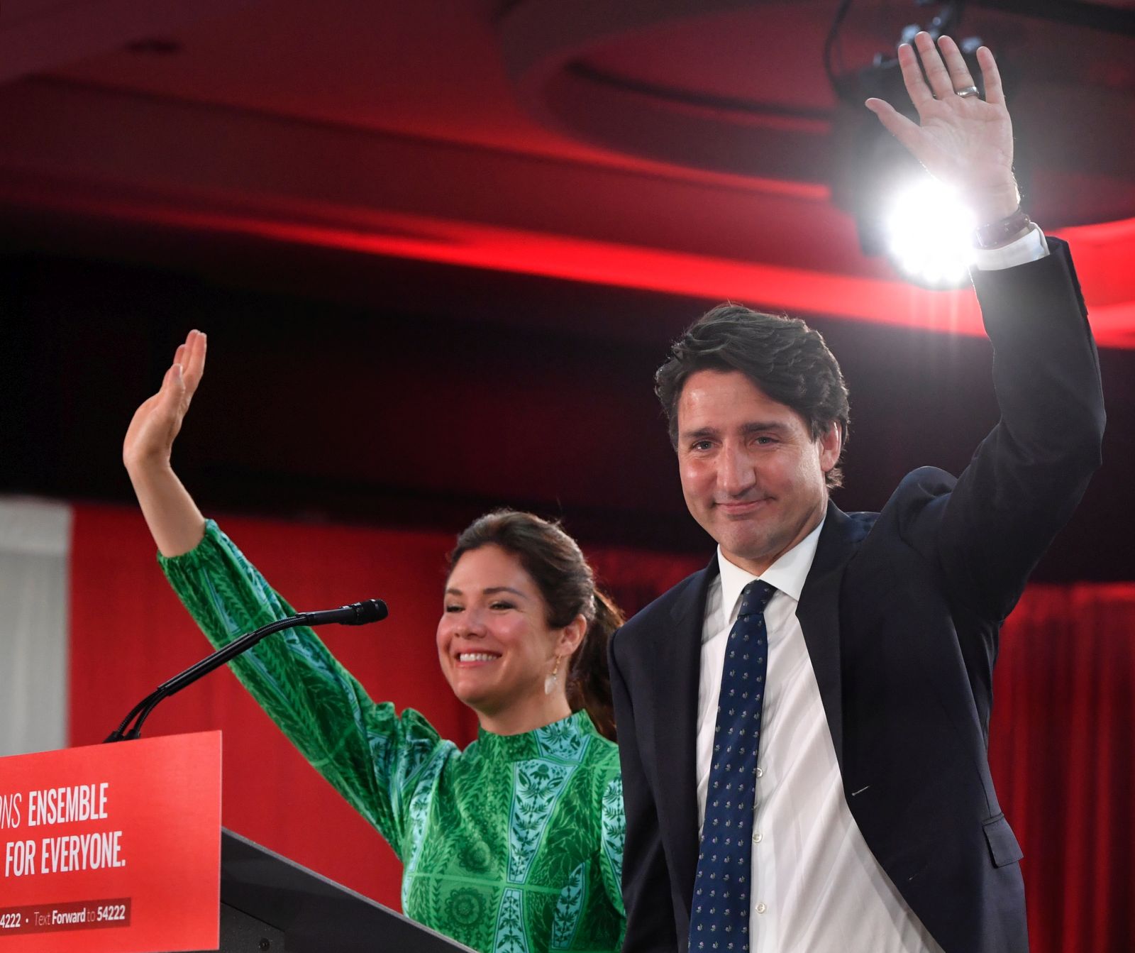 epa09478681 Canadian Prime Minister and Liberal Party leader Justin Trudeau (R), next to his wife Sophie Gregoire (L), waves to supporters as he celebrates his election victory in Montreal, Quebec, Canada, 20 September 2021. Liberal Party leader Justin Trudeau retained his position as Canadian prime minister in the federal election but will be forced to form a minority government.  EPA/ERIC BOLTE
