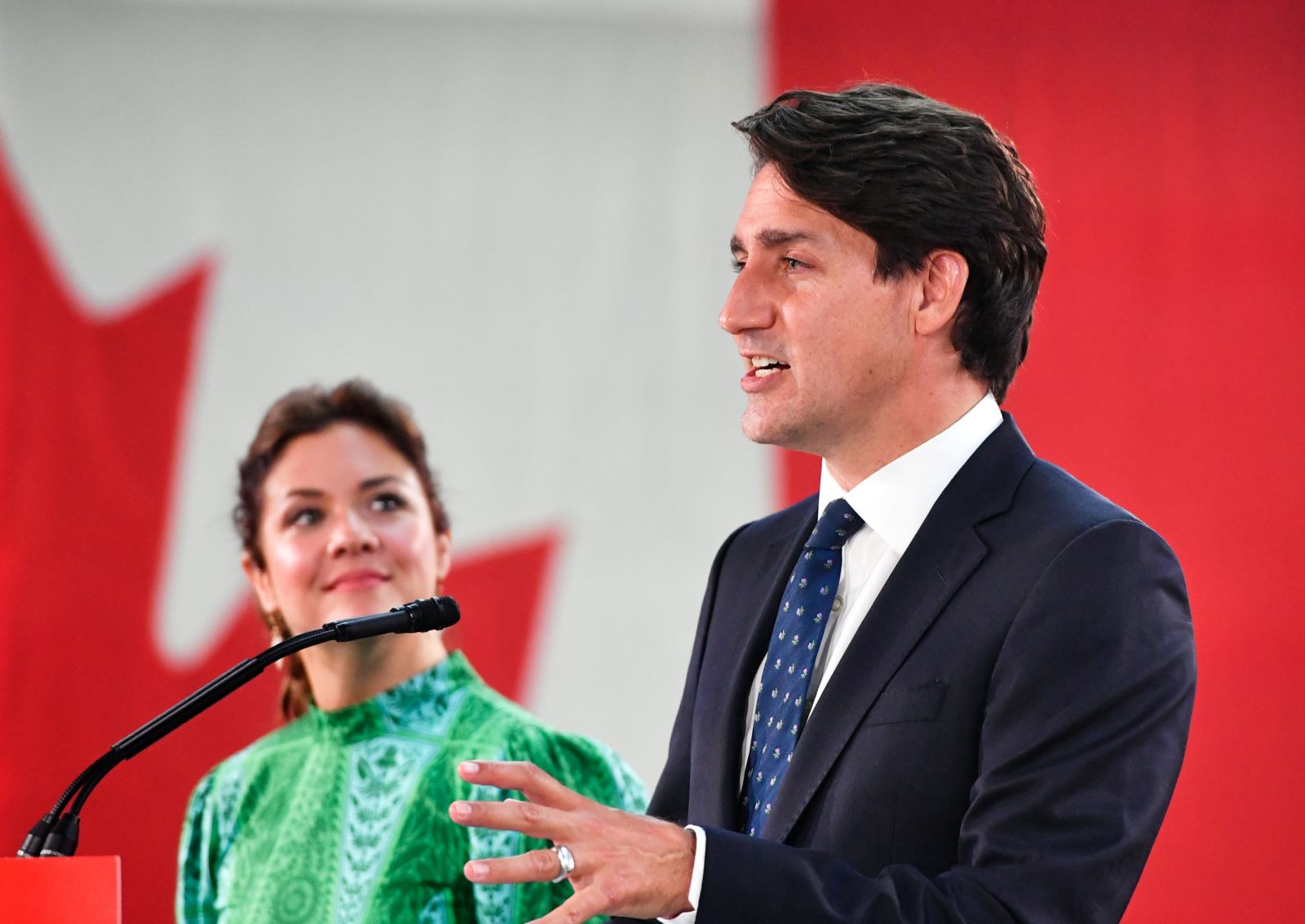 epa09478678 Canadian Prime Minister and Liberal Party leader Justin Trudeau (R), next to his wife Sophie Gregoire (L), addresses supporters as he celebrates his election victory in Montreal, Quebec, Canada, 20 September 2021. Liberal Party leader Justin Trudeau retained his position as Canadian prime minister in the federal election but will be forced to form a minority government.  EPA/ERIC BOLTE